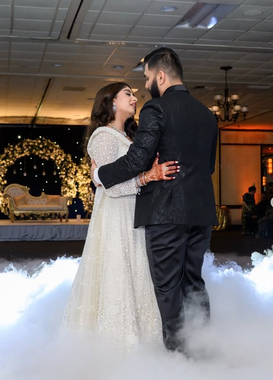 Couple sharing their first dance on a cloud of fog in the ballroom at Wyndham Garden York in York, PA