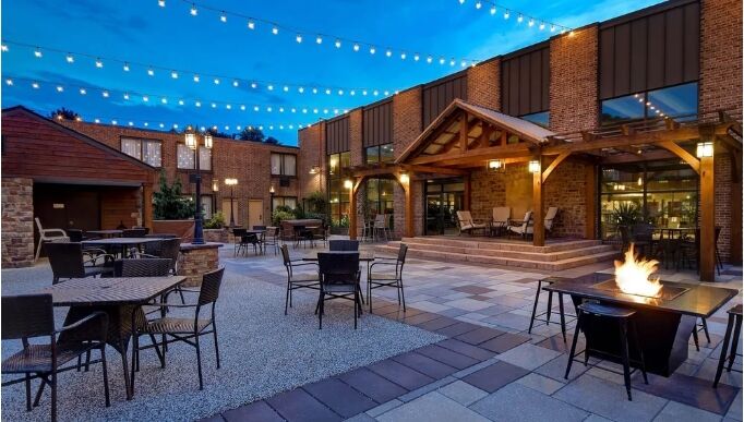 Outdoor courtyard wedding venue with string lights, fire pit, and pavilion at Wyndham Garden York in York, PA